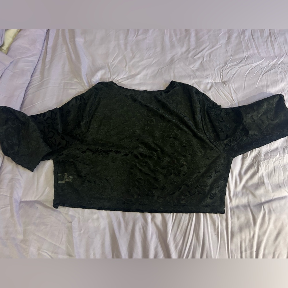 Cropped, lightly see through black shirt. Size 4x but tight fitting.
